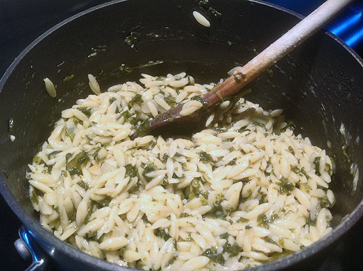 Stir in the spinach and let it wilt in the warm orzo.